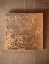 a large piece of metal hanging on a wall