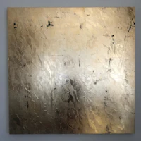 a gold and black painting on a wall