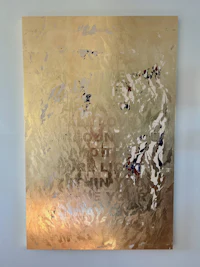 a gold and blue painting on a wall